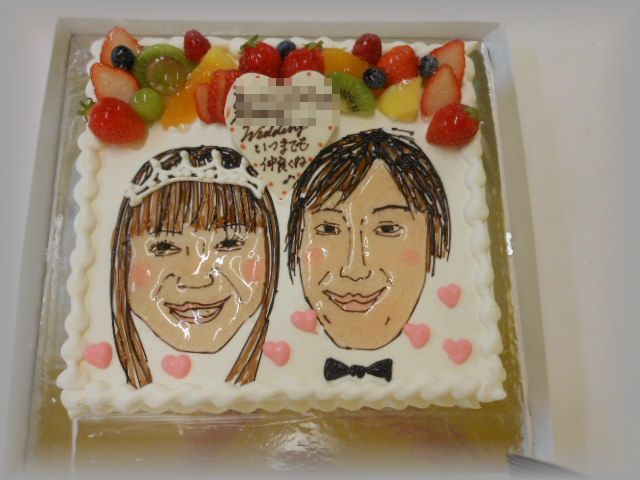 ２０１２年２月のご注文です。１５～６名様くらいのサイズのケーキにお二人の似顔絵を描きました。